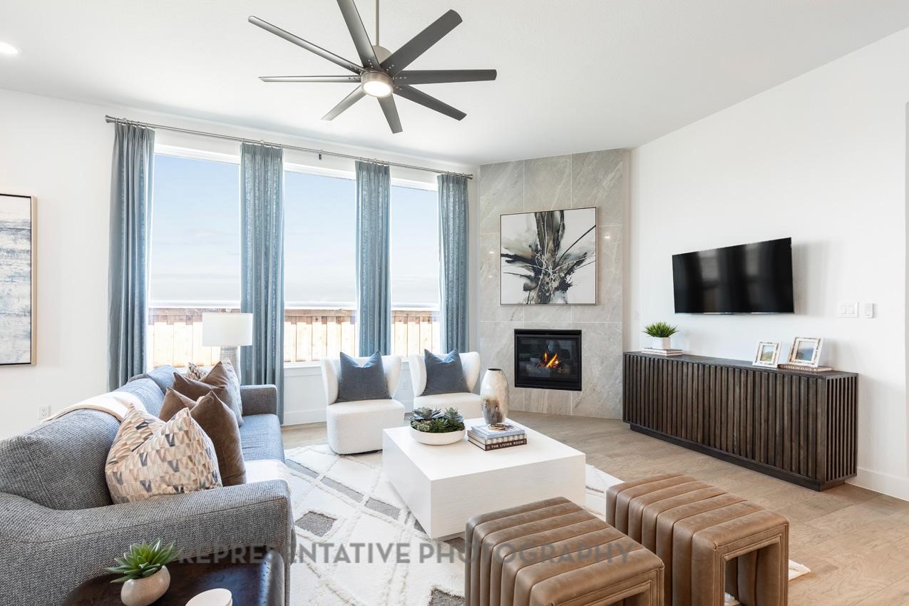 22214 Mount Whitney Road Waller, TX 77484 - Photo 14 of 50 a living room with furniture a fireplace and a flat screen tv