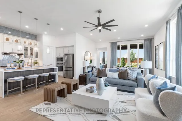 a living room with furniture a large window and a fireplace