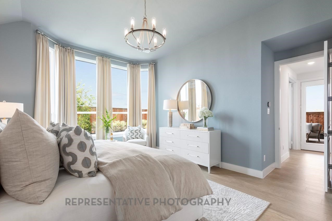 22214 Mount Whitney Road Waller, TX 77484 - Photo 19 of 50 a bed room with a bed and a chandelier