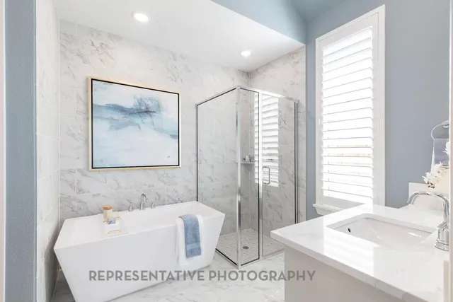 a bathroom with a tub a sink and a mirror