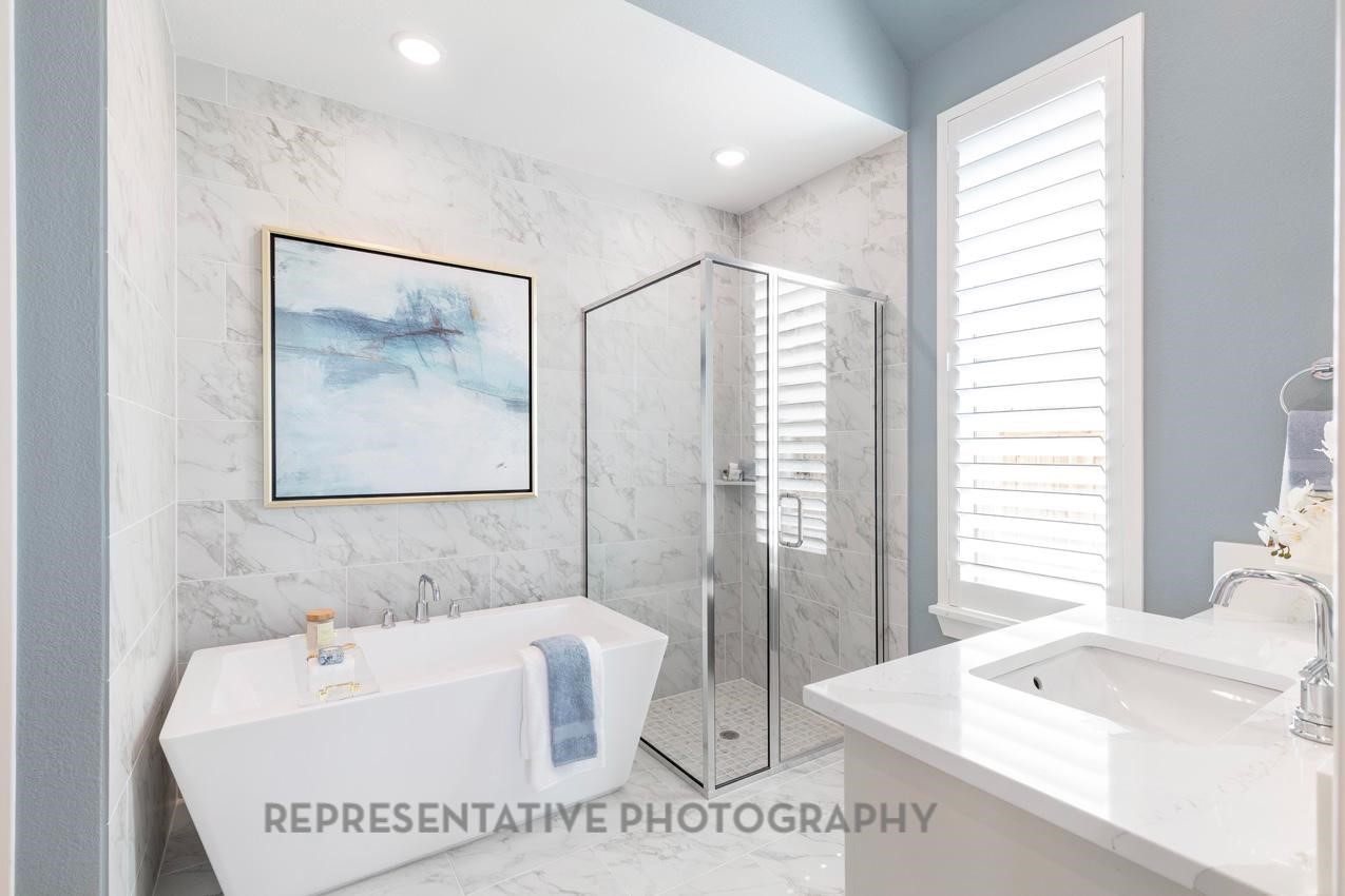22214 Mount Whitney Road Waller, TX 77484 - Photo 24 of 50 a bathroom with a tub a sink and a large mirror