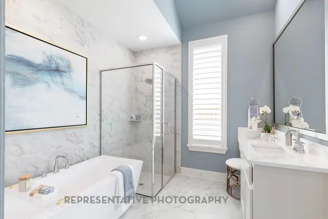 a spacious bathroom with a tub sink and mirror