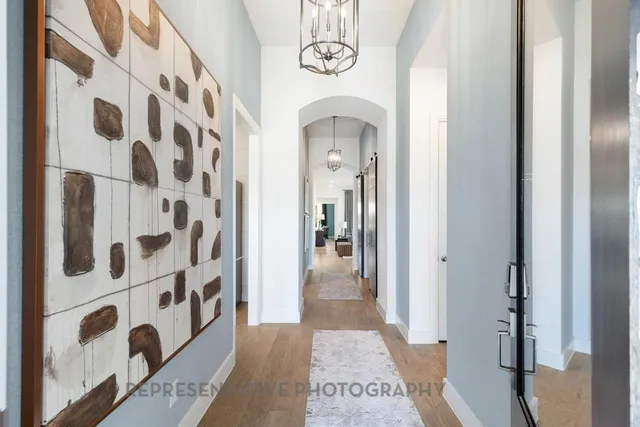 a bedroom with a bed and a lamp on dresser