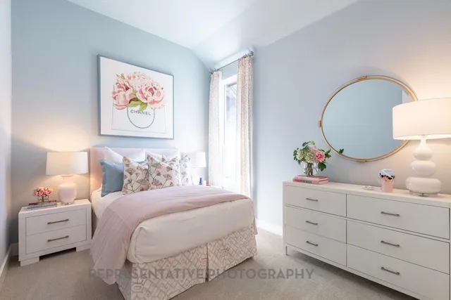 a bedroom with a bed and painting on the wall