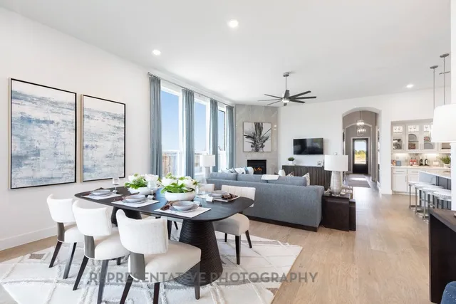 a living room with lots of furniture and view of kitchen