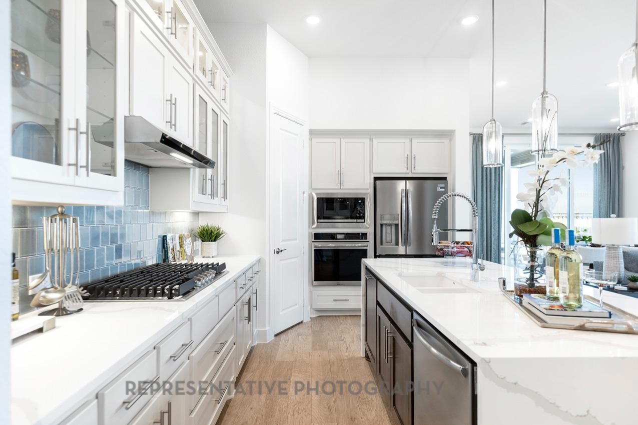 22214 Mount Whitney Road Waller, TX 77484 - Photo 8 of 50 a kitchen with stainless steel appliances a sink stove and refrigerator