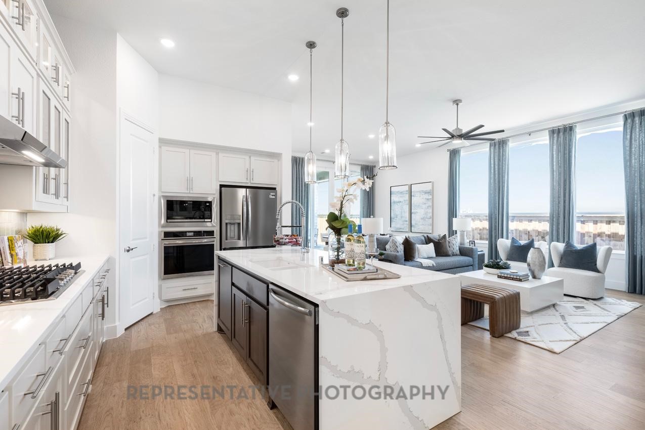 22214 Mount Whitney Road Waller, TX 77484 - Photo 10 of 50 a large kitchen with kitchen island a large counter top appliances and cabinets