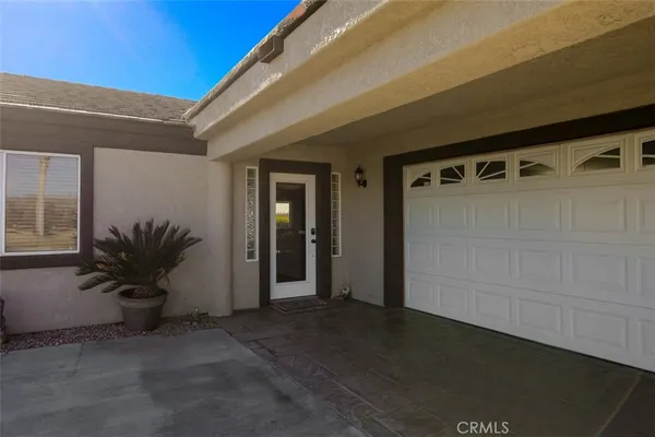 a view of a door and chair in front of a house