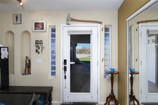 a view of a hallway with windows and closet
