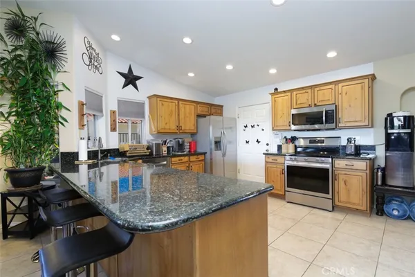a kitchen with stainless steel appliances granite countertop a stove sink and cabinets