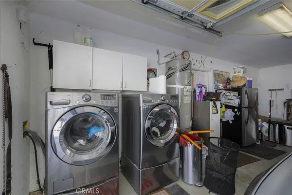 a view of a storage and utility room with washer and dryer