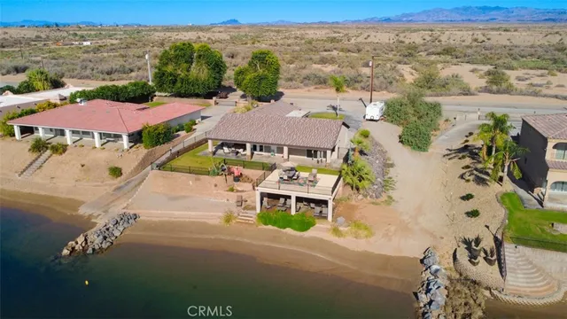 a view of a white house with a swimming pool