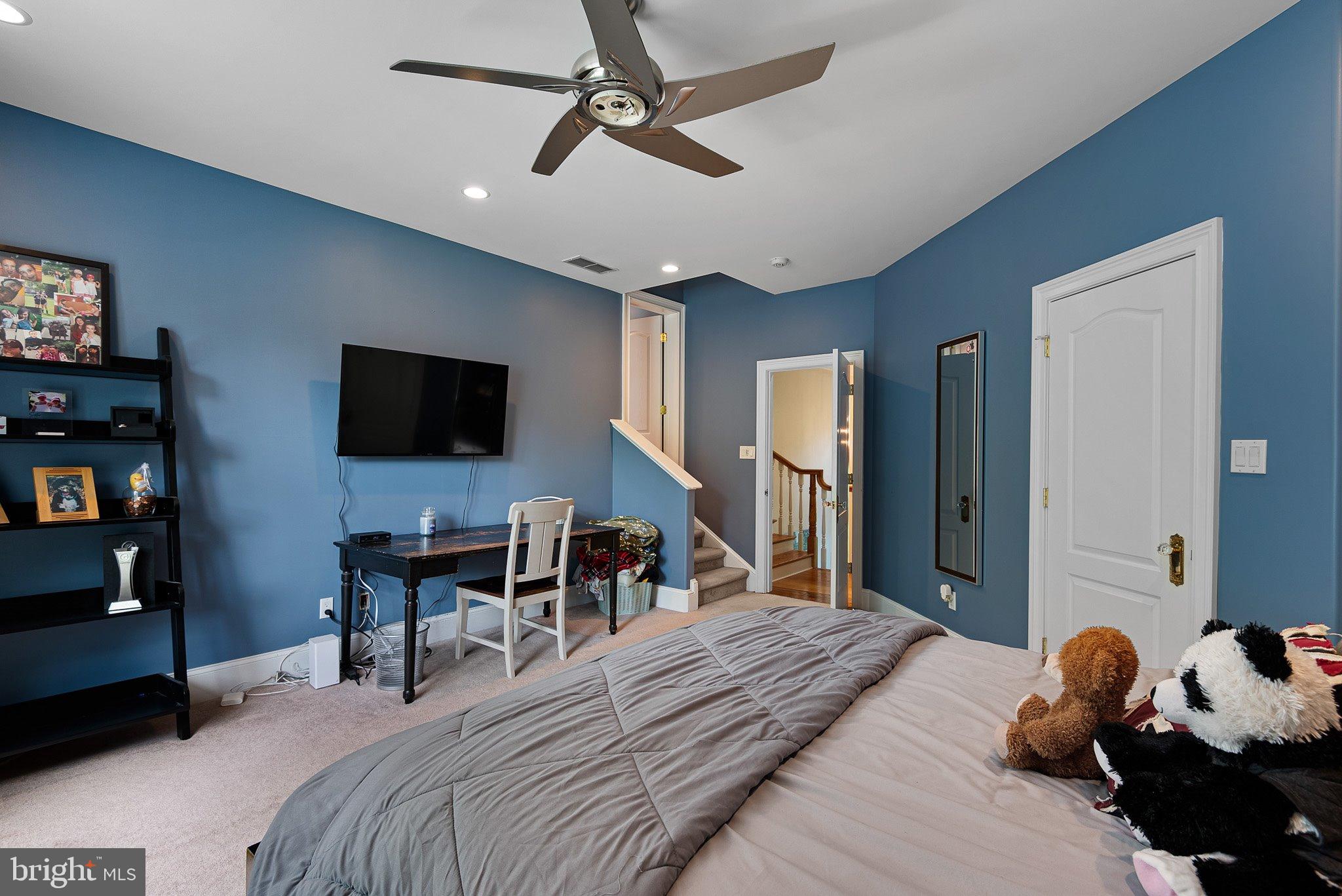 104 Timber Ridge Lane Chadds Ford, PA 19317 - Photo 44 of 65 a bedroom with a bed and a flat tv screen on wall