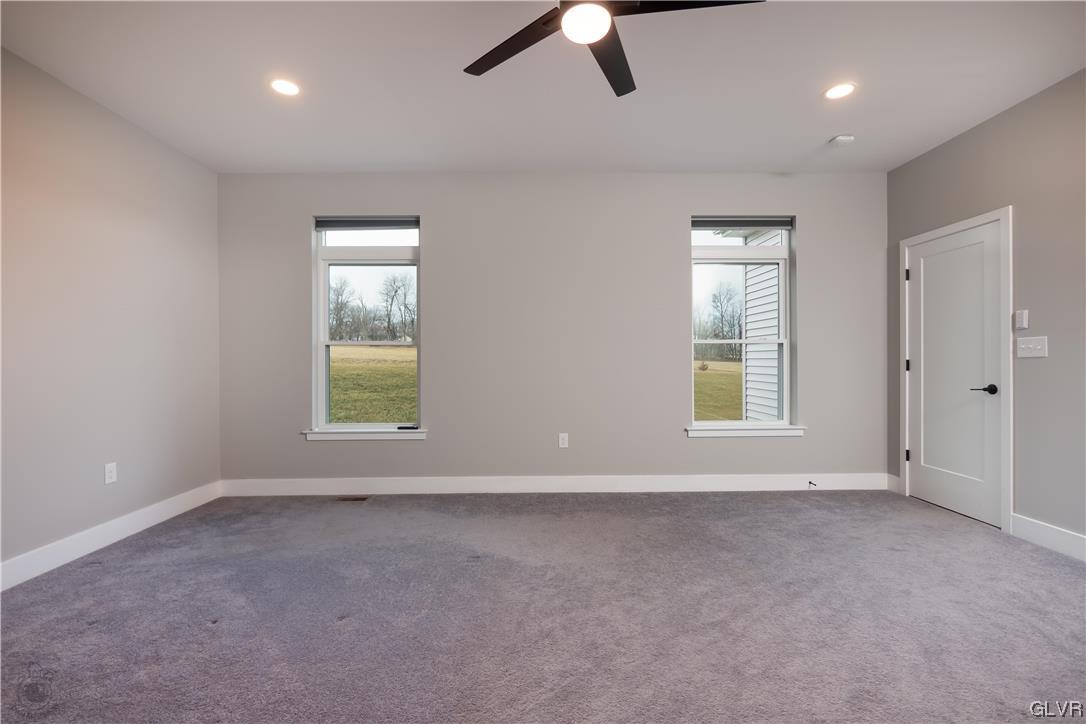 785 Emerald Valley Lane Bangor, PA 18013 - Photo 13 of 28 an empty room with ceiling fan and windows