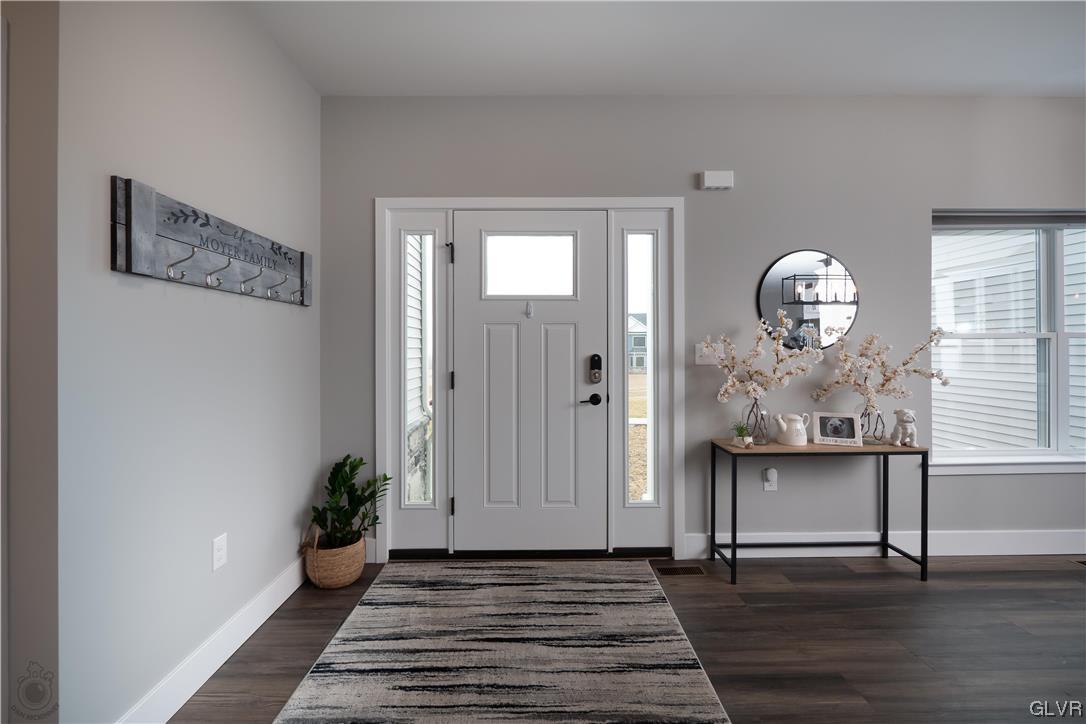785 Emerald Valley Lane Bangor, PA 18013 - Photo 3 of 28 a view of a hallway with wooden floor and a chandelier