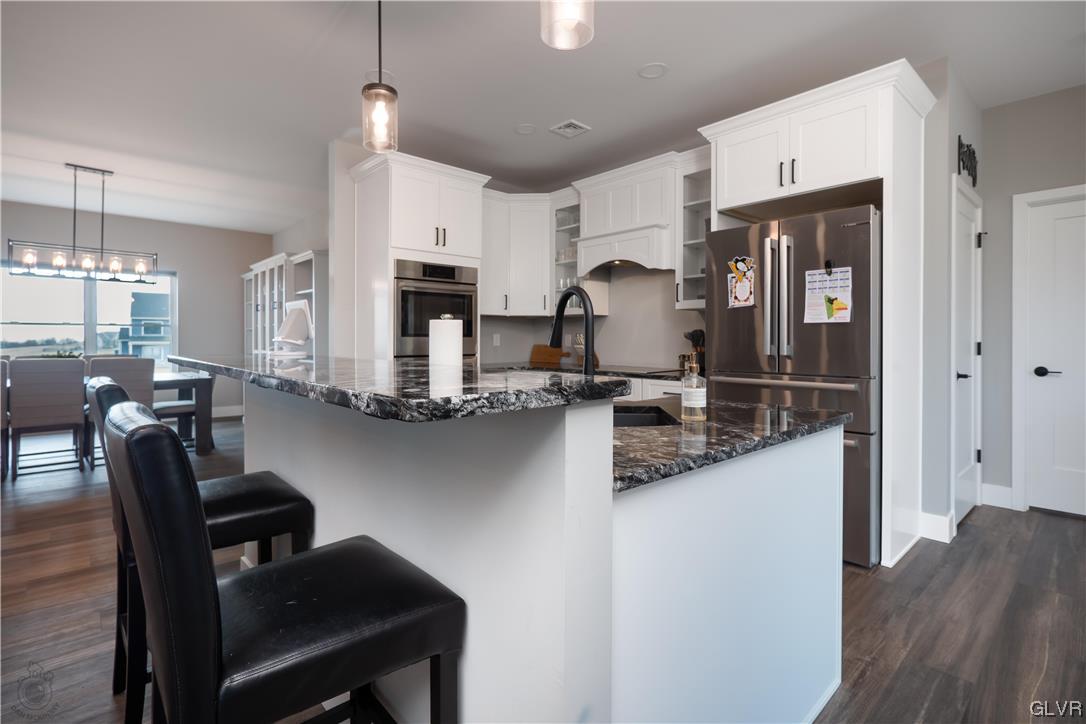 785 Emerald Valley Lane Bangor, PA 18013 - Photo 8 of 28 a kitchen with refrigerator and chairs