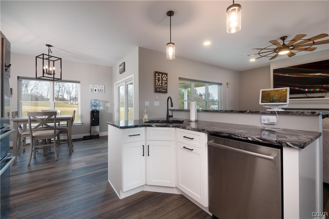 785 Emerald Valley Lane Bangor, PA 18013 - Photo 10 of 28 a kitchen with granite countertop a stove a sink a dining table and chairs