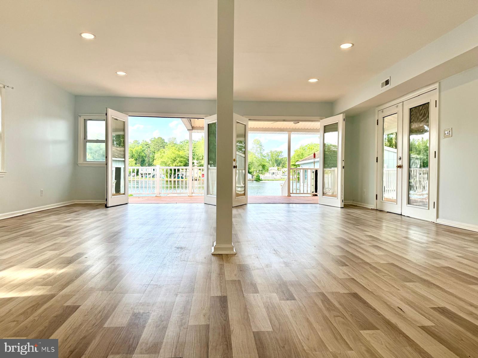 3614 Lakeside Drive Williamstown, NJ 08094 - Photo 4 of 40 an empty room with wooden floor and windows