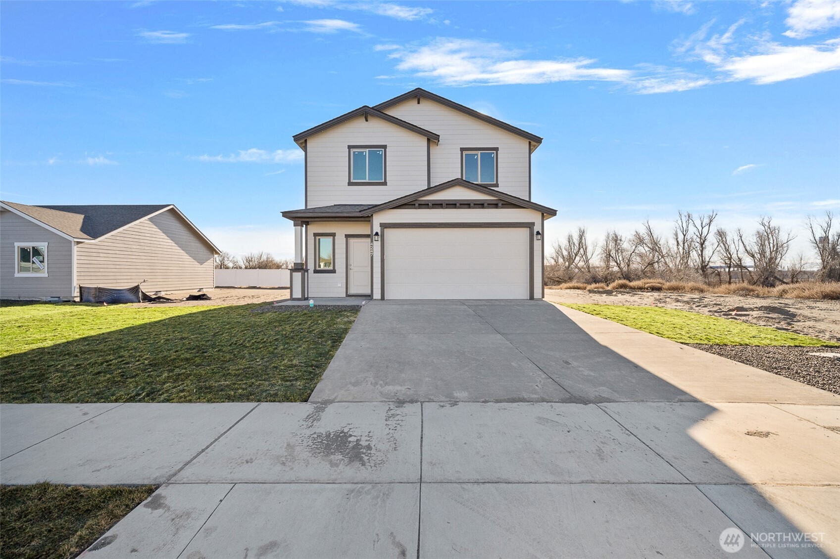 4247 Sandy Street Moses Lake, WA 98837 - Photo 1 of 24 a front view of a house with a yard and garage