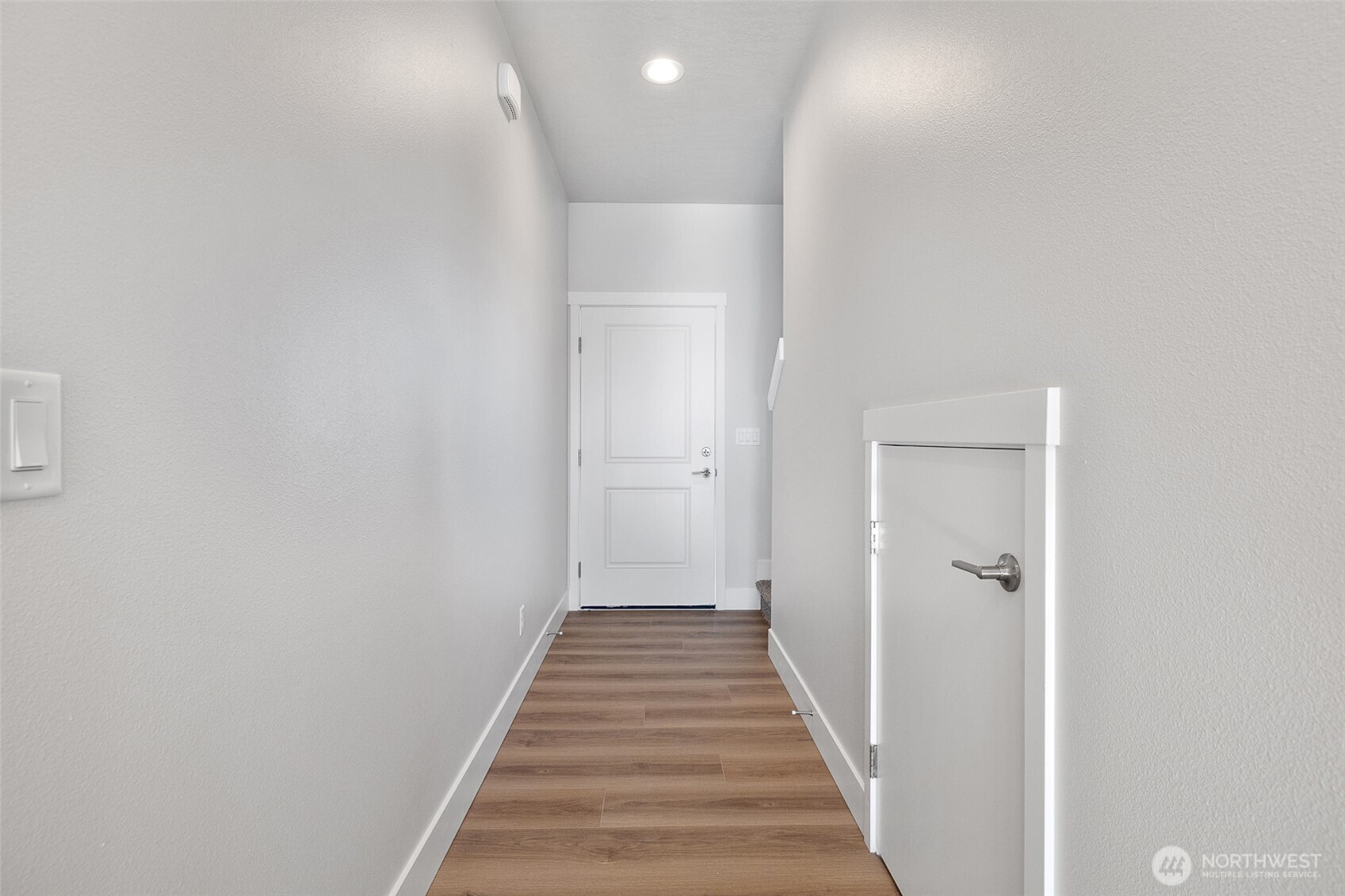 4247 Sandy Street Moses Lake, WA 98837 - Photo 11 of 24 a view of a hallway with wooden floor and a bathroom