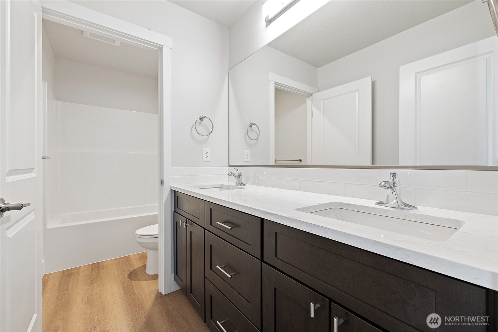 4247 Sandy Street Moses Lake, WA 98837 - Photo 16 of 24 a bathroom with a granite countertop sink toilet a large mirror and shower