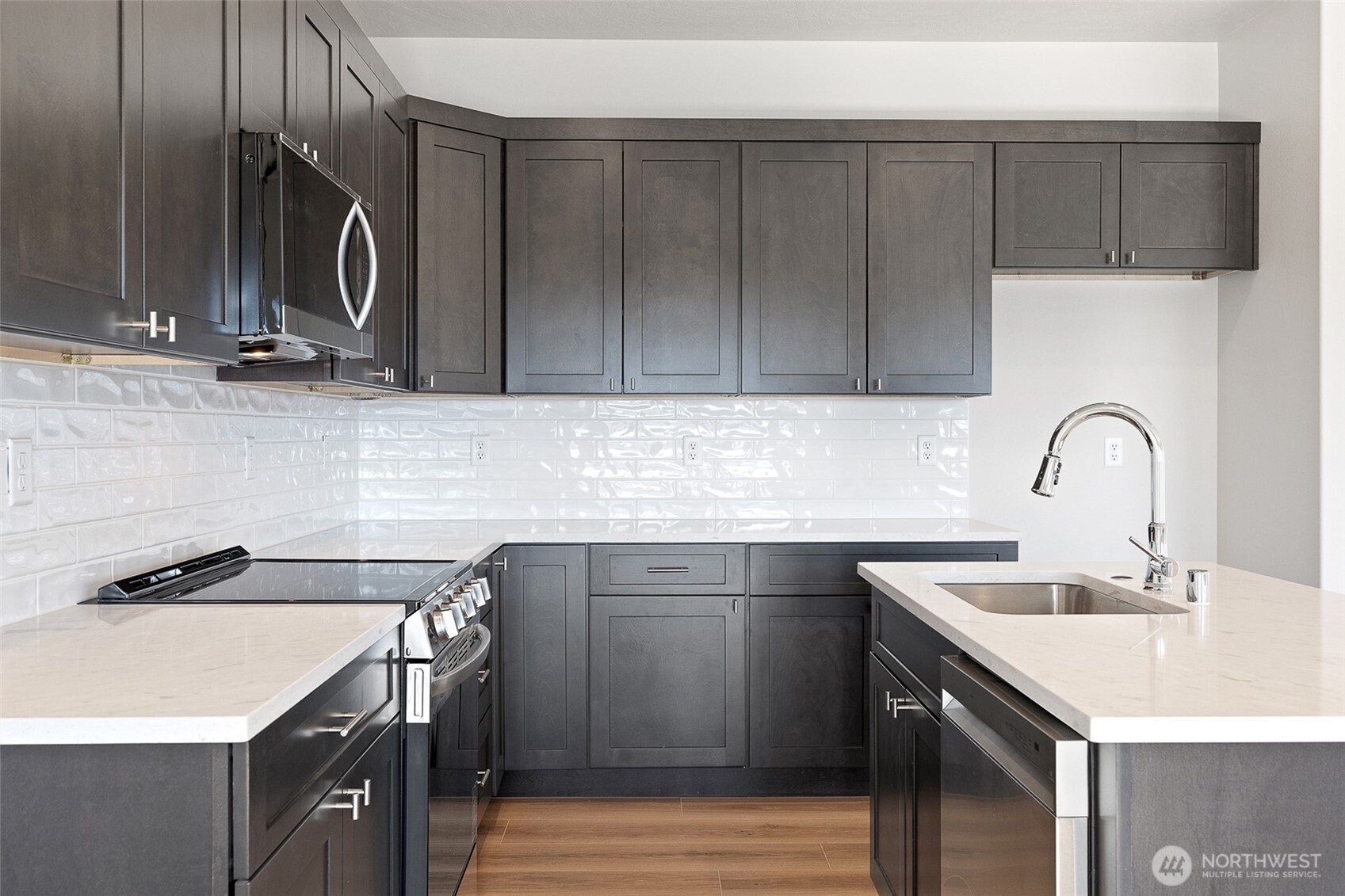4247 Sandy Street Moses Lake, WA 98837 - Photo 8 of 24 a kitchen with a sink cabinets and stainless steel appliances