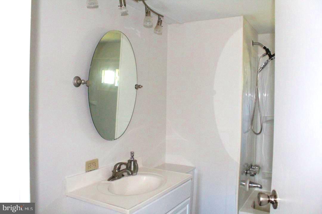 1762 Crown Point Road, Unit 2310B West Deptford, NJ 08086 - Photo 15 of 39 a bathroom with a sink and mirror