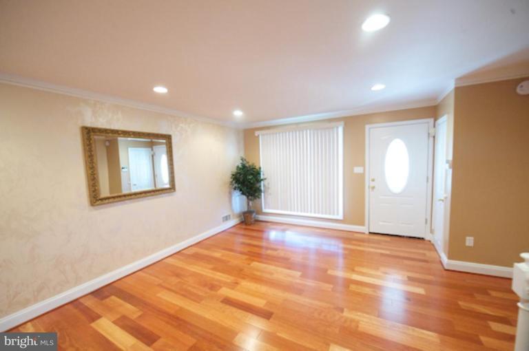 1968 Haselmere Road Dundalk, MD 21222 - Photo 1 of 16 a view of an empty room with wooden floor and a window