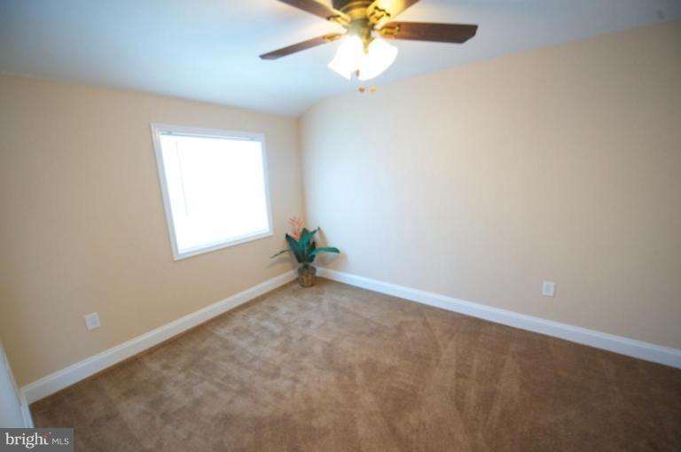 1968 Haselmere Road Dundalk, MD 21222 - Photo 15 of 16 an empty room with a window and a fan