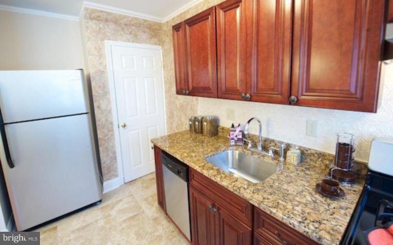 1968 Haselmere Road Dundalk, MD 21222 - Photo 3 of 16 a kitchen with a sink a refrigerator and a stove top oven