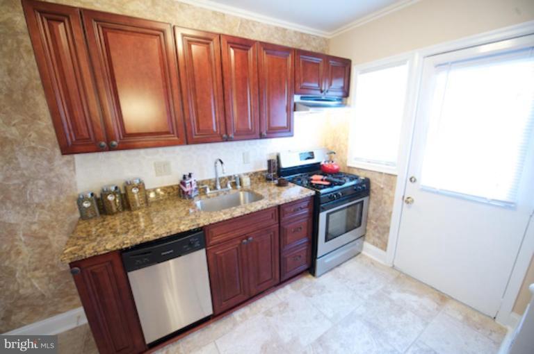 1968 Haselmere Road Dundalk, MD 21222 - Photo 4 of 16 a kitchen with granite countertop cabinets and window