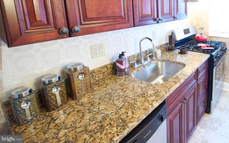 1968 Haselmere Road Dundalk, MD 21222 - Photo 5 of 16 a kitchen with a sink stove and cabinets
