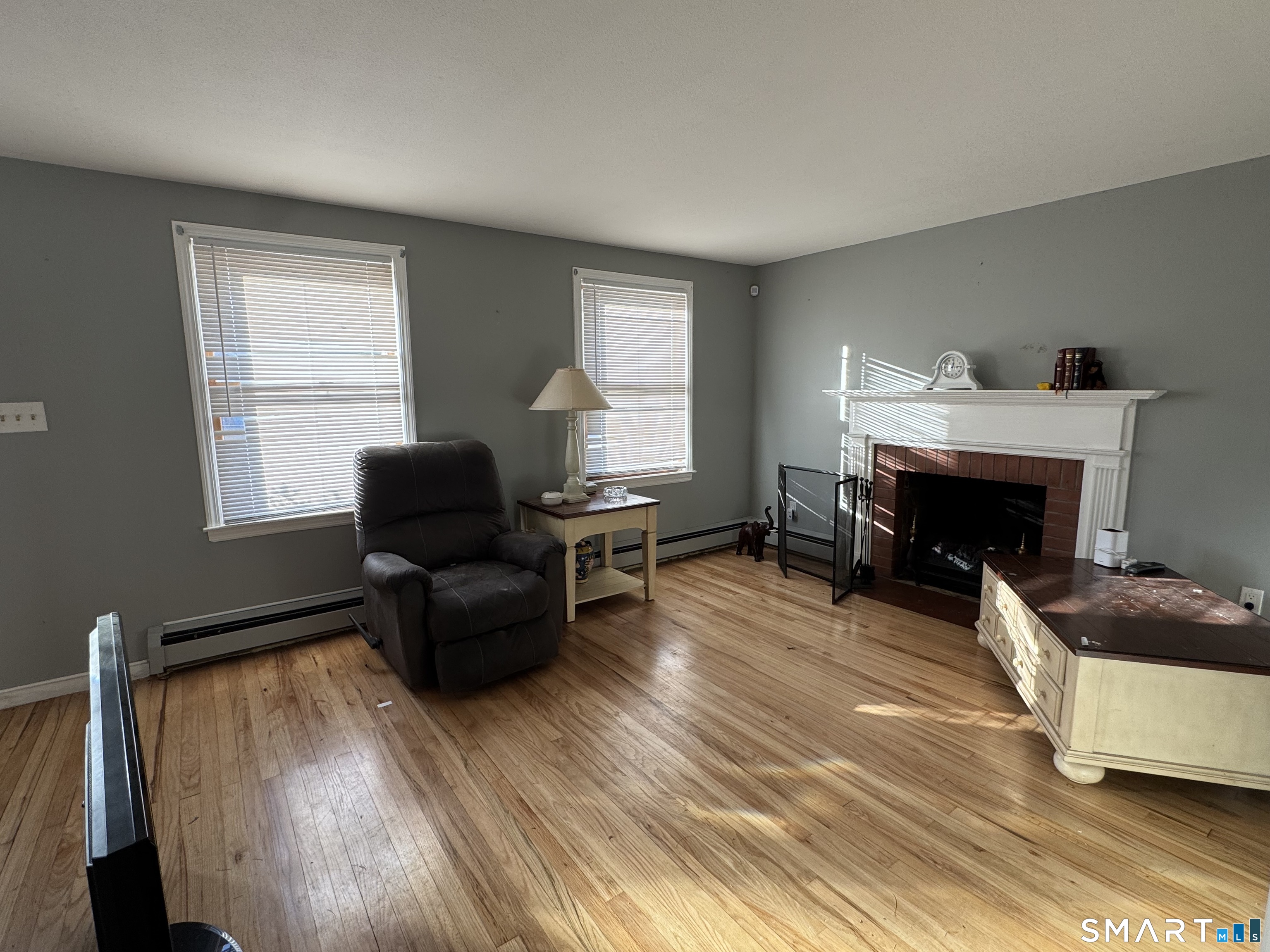 404 Woodland Street Windsor Locks, CT 06096 - Photo 4 of 8 a living room with furniture and a fireplace