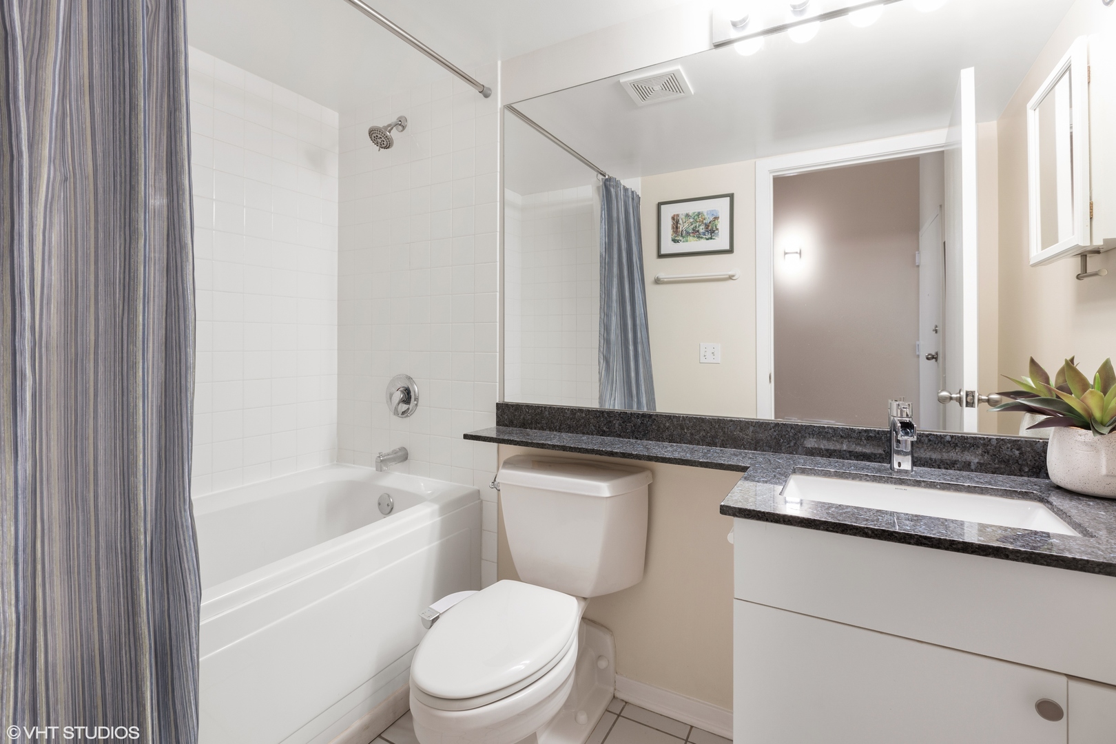 500 South Clinton Street, Unit 722 Chicago, IL 60607 - Photo 12 of 21 a bathroom with a granite countertop sink toilet and shower