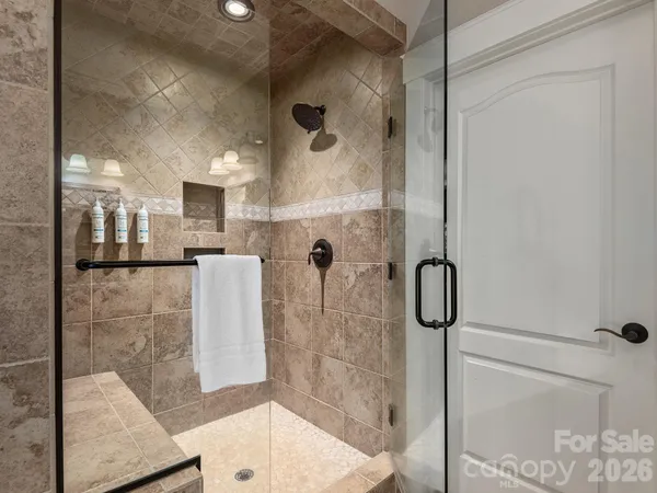 a bathroom with a granite countertop sink a toilet and a mirror