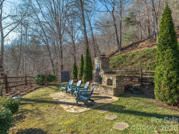 a view of backyard with swimming pool and outdoor seating