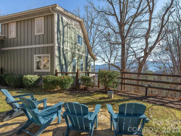 a view of a backyard with wooden fence