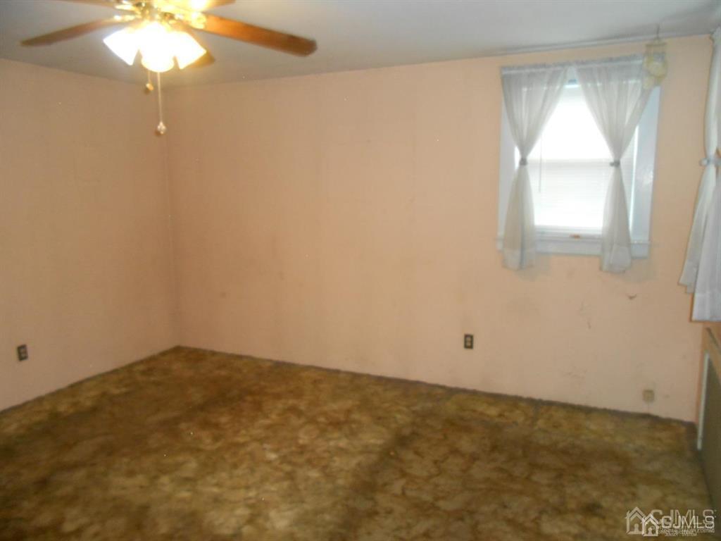 48 Frederick Street Carteret, NJ 07008 - Photo 11 of 16 an empty room with a window