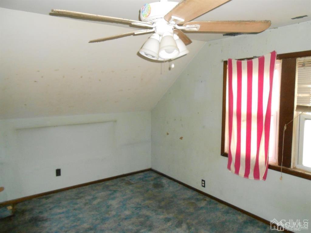 48 Frederick Street Carteret, NJ 07008 - Photo 16 of 16 an empty room with windows and fan