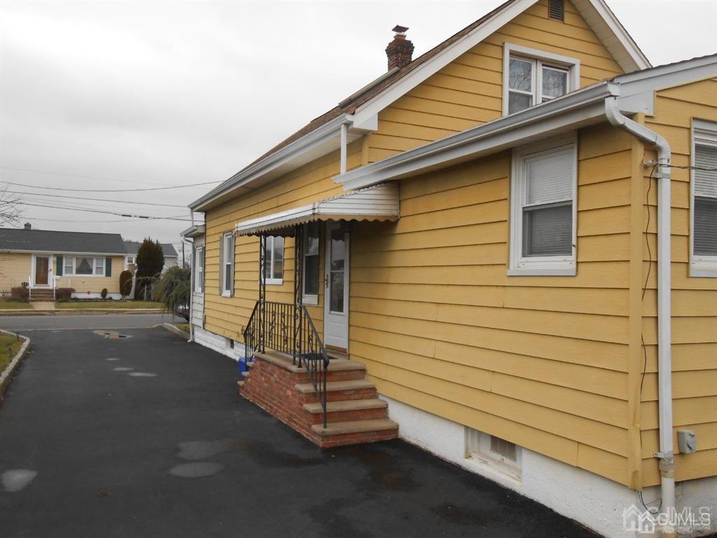 48 Frederick Street Carteret, NJ 07008 - Photo 3 of 16 a front view of a house with a yard