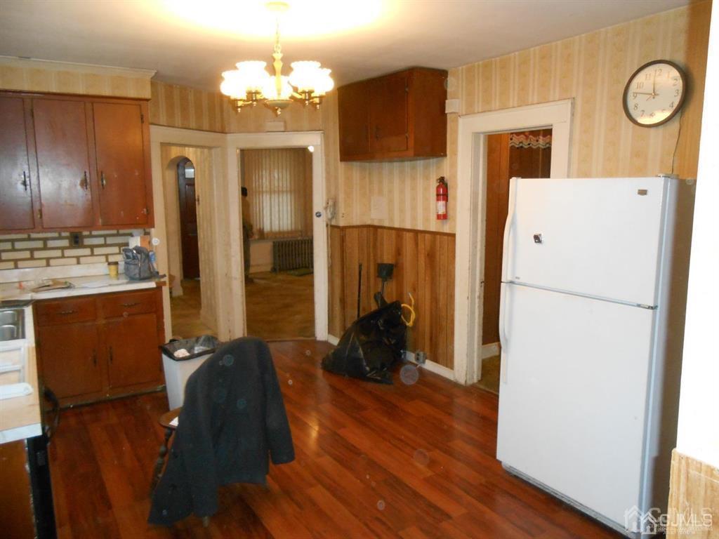48 Frederick Street Carteret, NJ 07008 - Photo 6 of 16 a kitchen with stainless steel appliances a refrigerator stove and microwave
