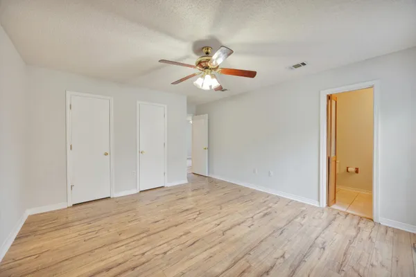 a view of a room with a ceiling fan