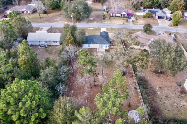 a view of backyard with outdoor seating and trees