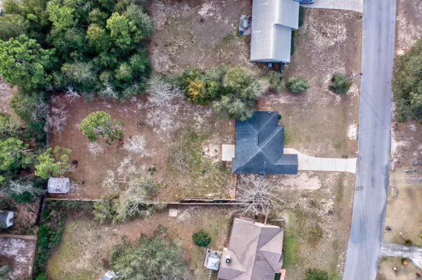 an aerial view of a house with a yard
