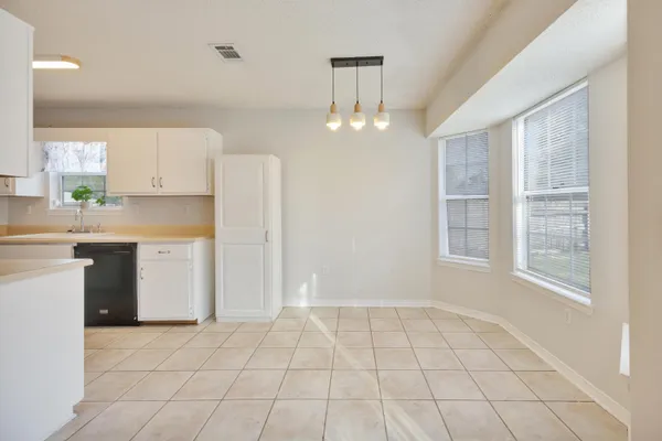 a view of a kitchen with a sink and dishwasher cabinets