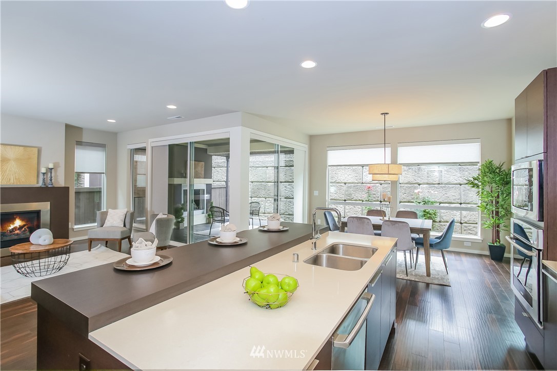 4108 168th Place Southeast Bothell, WA 98012 - Photo 7 of 39 a kitchen with a table chairs and wooden floor