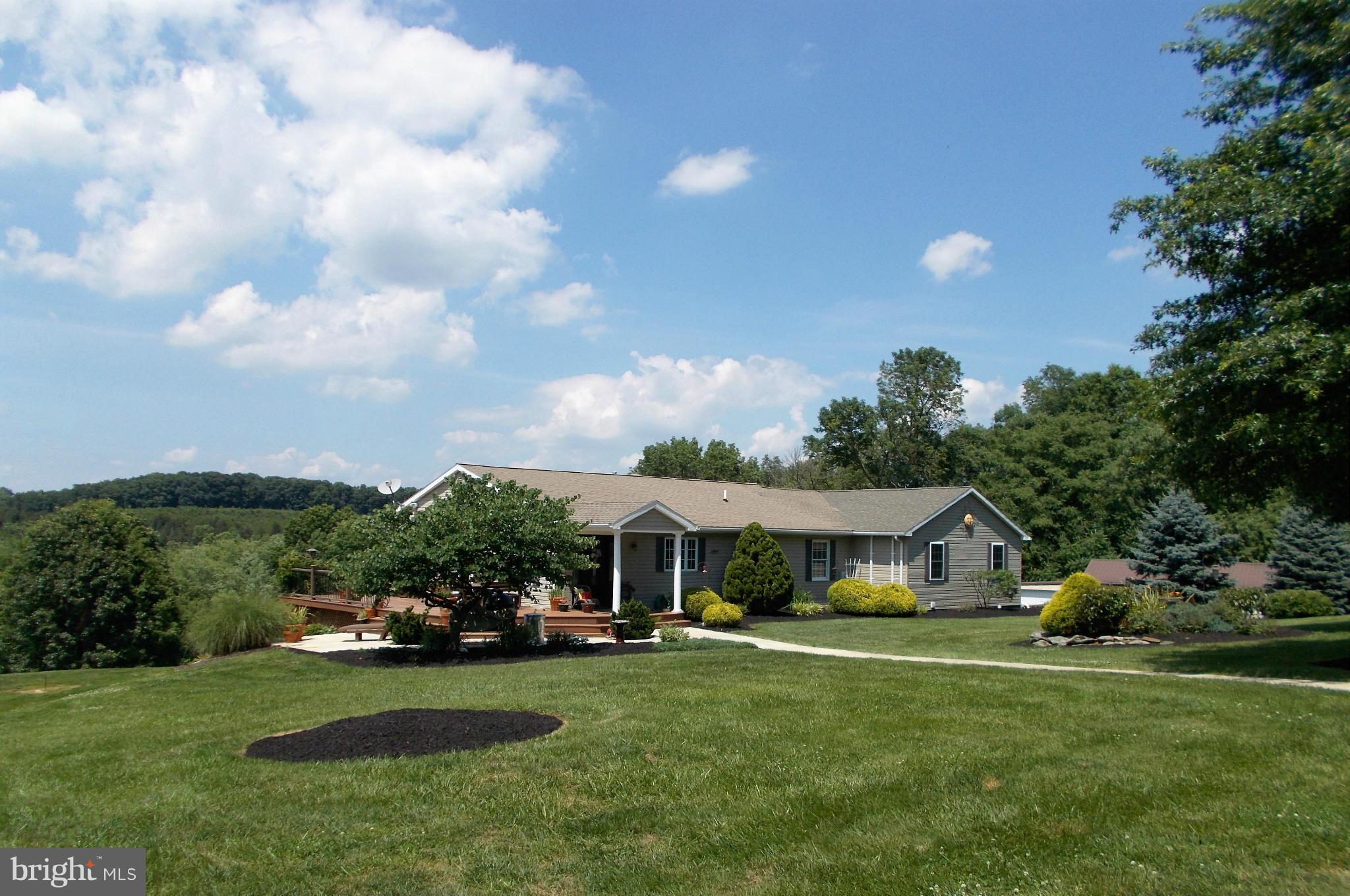 15712 Spade Road Hagerstown, MD 21740 - Photo 1 of 30 a front view of a house with garden