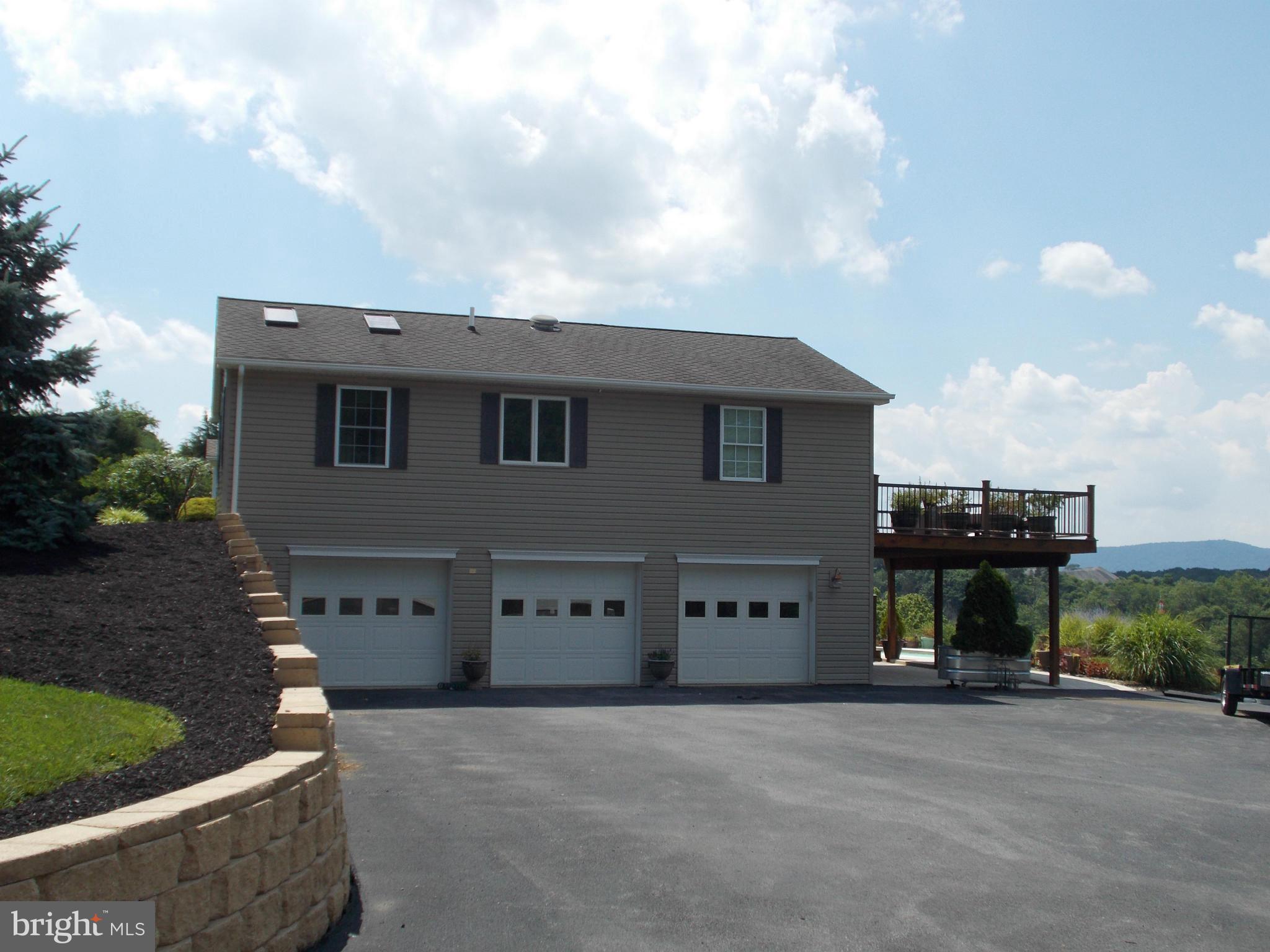 15712 Spade Road Hagerstown, MD 21740 - Photo 23 of 30 a front view of a house with a yard and garage