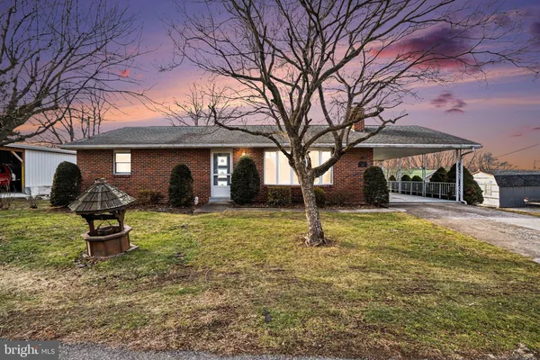 a view of a house with a yard and sitting area