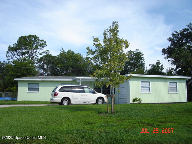 2829 Shepard Drive Rockledge, FL 32955 - Photo 1 of 1 a white house covered with tall trees